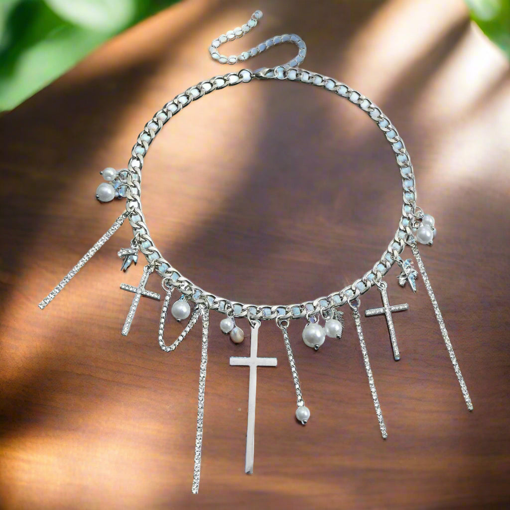 A Stylish Cross pendant adorned with Sparkling Diamond-like stones a Flowing Tassel element adds Movement and Sophistication to the Necklace
