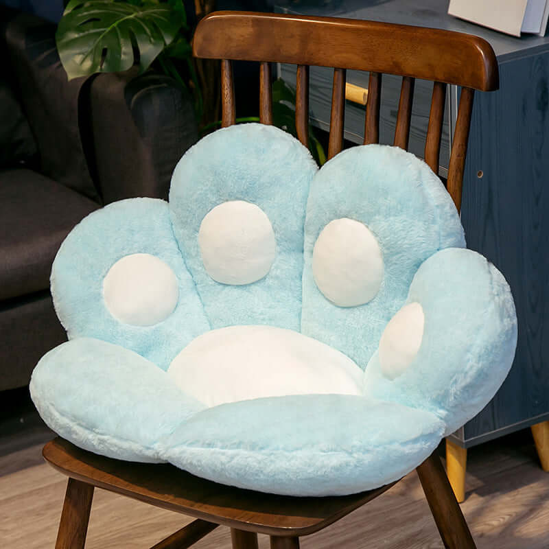 Blue cat paw shaped seat cushion on wooden chair, perfect for kids' rooms, made of plush material with PP cotton filling
