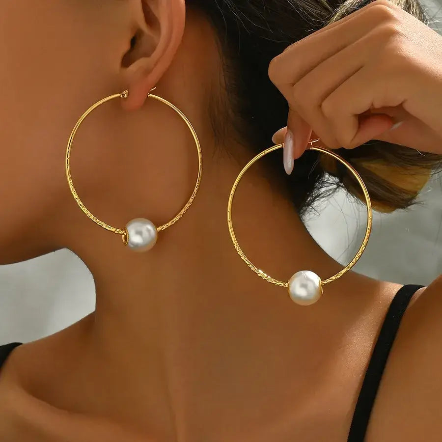 Stunning 18K gold-plated hoop earrings with pearl detail, perfect for adding elegance to any outfit.