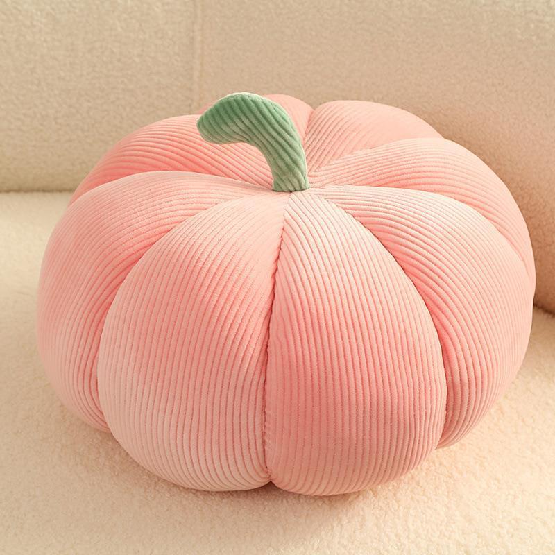 Pink pumpkin-shaped throw pillow with green stem, perfect for modern simplicity Thanksgiving decor. Plush and cozy for any living space.